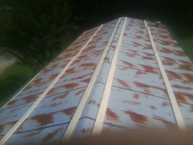 Rusted metal roof panels with new wood purlins before replacement — Storm Damage Roof Repair in Berkeley by Roofing Brothers